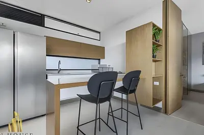 a kitchen with two black stools at a counter at Q Tower 506 - Bright & Chic Loft In Poblado in Las Palmas