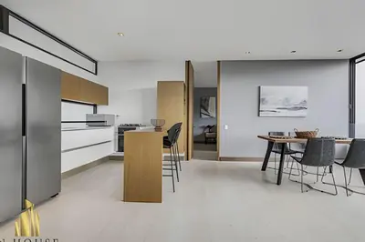 a kitchen and dining room with a table and chairs at Q Tower 506 - Bright & Chic Loft In Poblado in Las Palmas
