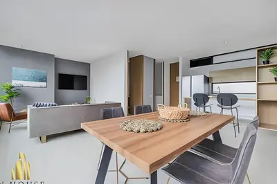 a kitchen and dining room with a wooden table and chairs at Q Tower 506 - Bright & Chic Loft In Poblado in Las Palmas