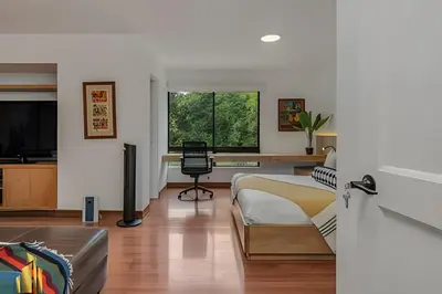 a bedroom with a bed and a desk with a chair at San Angel 205-Familiar & Trendy apt near Provenza in El Poblado