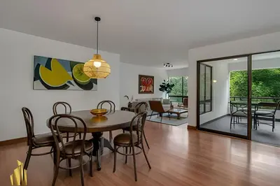 a dining room and living room with a table and chairs at San Angel 205-Familiar & Trendy apt near Provenza in El Poblado