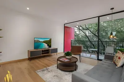 a living room with a couch and a tv at Santacoloma 407 Apto tranquilo con vistas verdes. AC in El Poblado