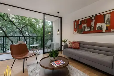 a living room with a couch and a table at Santacoloma 407 Apto tranquilo con vistas verdes. AC in El Poblado