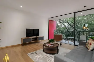 a living room with a couch and a tv at Santacoloma 407 Apto tranquilo con vistas verdes. AC in El Poblado
