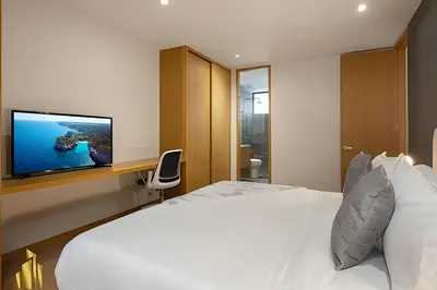 a bedroom with a bed and a tv on a wall at Santacoloma 407 Apto tranquilo con vistas verdes. AC in El Poblado