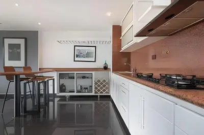 a kitchen with white cabinets and a table in it at Santiago De Bagatela 1104 - Spacious apt Poblado in Envigado