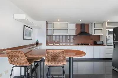a kitchen with a wooden table and two chairs at Santiago De Bagatela 1104 - Spacious apt Poblado in Envigado