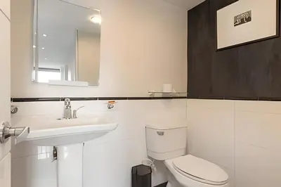 a white bathroom with a toilet and a sink at Santiago De Bagatela 1104 - Spacious apt Poblado in Envigado