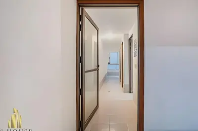 a hallway with a glass door with a hallway leading into a room at Santiago De Bagatela 401 - Serene apt/sauna & gym in Envigado