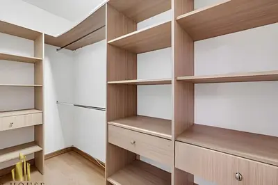 a closet with wooden shelves and a refrigerator at Santiago De Bagatela 401 - Serene apt/sauna & gym in Envigado