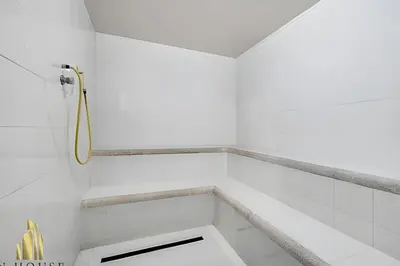 a white bathroom with a shower in a room at Santiago De Bagatela 401 - Serene apt/sauna & gym in Envigado