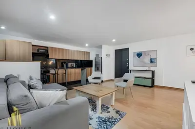 a living room with a couch and a table at Santiago De Bagatela 401 - Serene apt/sauna & gym in Envigado