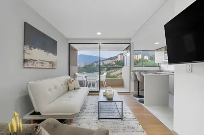 a living room with a white couch and a table at Scala 1901 - Serene apt/balcony/deluxe furniture in Sabaneta