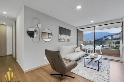 a white living room with a couch and a table at Scala 1901 - Serene apt/balcony/deluxe furniture in Sabaneta