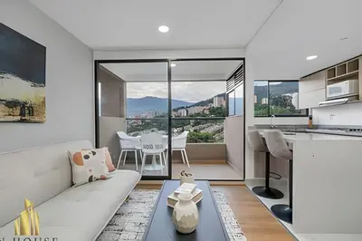 a kitchen and living room with a couch and a table at Scala 1901 - Serene apt/balcony/deluxe furniture in Sabaneta