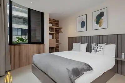 a bedroom with a large bed and a window at Solei Loft 201 - Luxe Stay in El Poblado in El Poblado