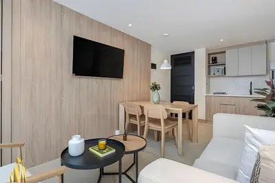 a living room with a couch and a table at Solei Loft 201 - Luxe Stay in El Poblado in El Poblado