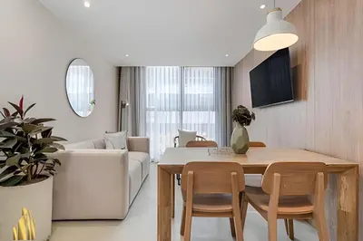 a kitchen and living room with a table and chairs at Solei Loft 201 - Luxe Stay in El Poblado in El Poblado
