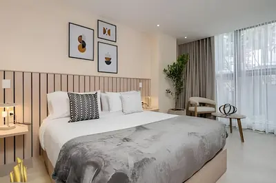 a bedroom with a large bed in a room at Solei Loft 202 - Chic Studio with AC in El Poblado