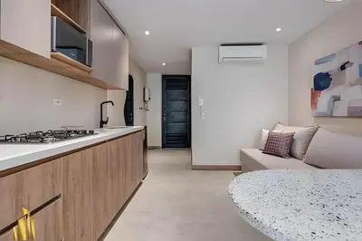 a kitchen and living room with a stove and a couch at Solei Loft 202 - Chic Studio with AC in El Poblado