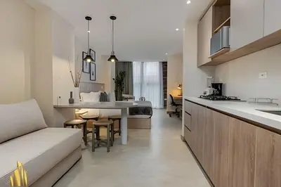 a kitchen and living room with a couch and a table at Solei Loft 202 - Chic Studio with AC in El Poblado