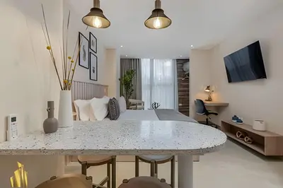 a living room with a bed and a table with chairs at Solei Loft 202 - Chic Studio with AC in El Poblado