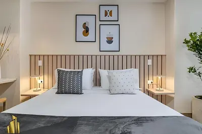 a bedroom with a large white bed with pillows at Solei Loft 202 - Chic Studio with AC in El Poblado