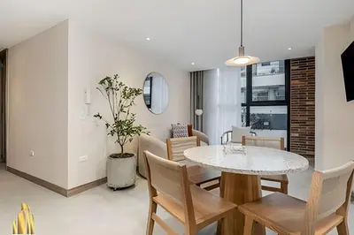 a dining room and living room with a table and chairs at Solei Loft 301 - Location/Trendy Jacuzzi Living in El Poblado