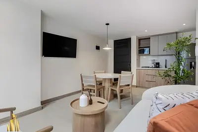 a living room with a couch and a table at Solei Loft 301 - Location/Trendy Jacuzzi Living in El Poblado