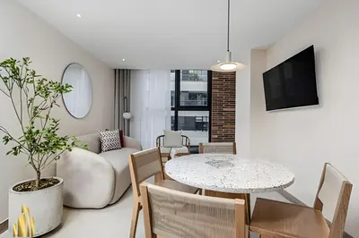 a living room with a table and a couch at Solei Loft 301 - Location/Trendy Jacuzzi Living in El Poblado