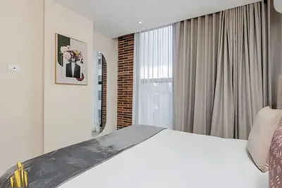 a bedroom with a white bed and a window at Solei Loft 301 - Location/Trendy Jacuzzi Living in El Poblado