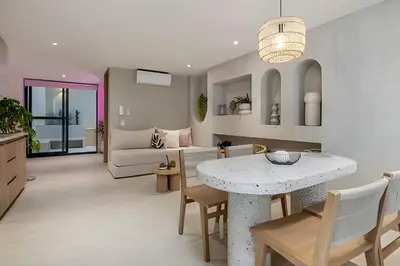 a living room with a table and a couch at Solei Loft 302 - Elegant Oasis: Loft/Jacuzzi/AC in El Poblado