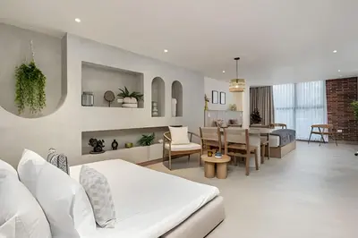 a living room with a table and a dining room at Solei Loft 302 - Elegant Oasis: Loft/Jacuzzi/AC in El Poblado