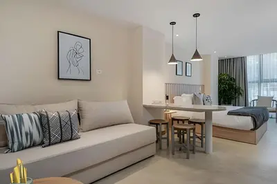 a living room with a couch and a dining room at Solei Loft 303 - Modern Loft in Poblado with AC in El Poblado