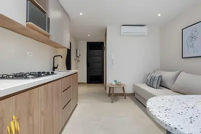 a kitchen and living room with a couch at Solei Loft 303 - Modern Loft in Poblado with AC in El Poblado