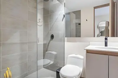 a bathroom with a shower and a toilet and a sink at Solei Loft 303 - Modern Loft in Poblado with AC in El Poblado