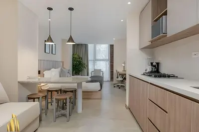 a kitchen and living room with a table and chairs at Solei Loft 303 - Modern Loft in Poblado with AC in El Poblado