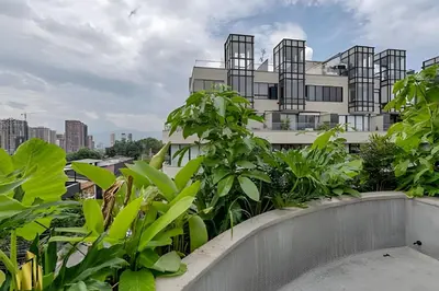 a building with green plants on a balcony at Solei Loft 401 - Elegance & Comfort /AC in Poblado in El Poblado