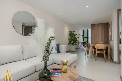 a living room with a white couch and a table at Solei Loft 401 - Elegance & Comfort /AC in Poblado in El Poblado