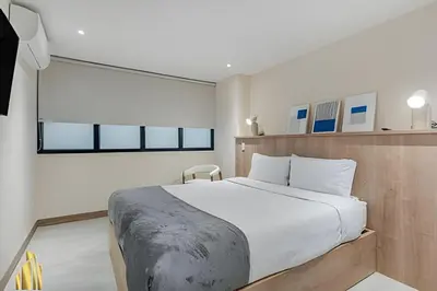 a bedroom with a large bed with white sheets at Solei Loft 402 - Espacious & bright apt with AC in El Poblado