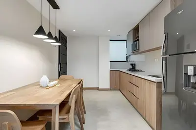 a kitchen with a wooden table and a dining room at Solei Loft 402 - Espacious & bright apt with AC in El Poblado