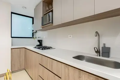 a kitchen with white counters and a sink at Solei Loft 402 - Espacious & bright apt with AC in El Poblado