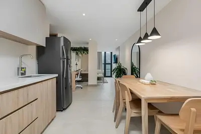 a kitchen with a wooden table and a refrigerator at Solei Loft 402 - Espacious & bright apt with AC in El Poblado