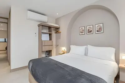 a bedroom with a large white bed in a room at Solei Loft 402 - Espacious & bright apt with AC in El Poblado