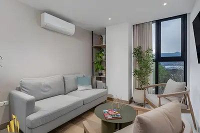 a living room with a couch and a table at Solei Loft 502 - Calm & cozy in Manila Poblado/AC in El Poblado