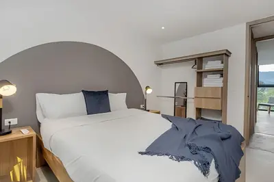 a bedroom with a large white bed and a window at Solei Loft 502 - Calm & cozy in Manila Poblado/AC in El Poblado