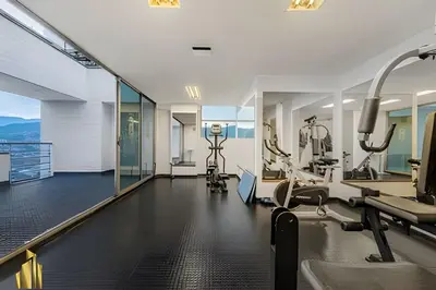 a gym with treadmills and ellipticals in a building at Torre 6 Sur - Trendy Loft: Balcony, AC / Poblado in El Poblado