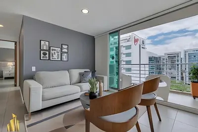 a living room with a couch and a table at Torre 6 Sur - Trendy Loft: Balcony, AC / Poblado in El Poblado
