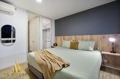 a bedroom with a large bed in a room at Urban 2005 - Serenity AC retreat: Soft decoration in El Poblado