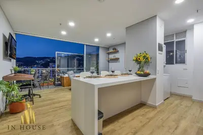 a kitchen with a white counter and a large window at Urban 2005 - Serenity AC retreat: Soft decoration in El Poblado